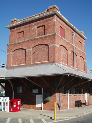 A red brick edifice showcasing a timeless design with multiple stories and arched windows.